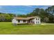 Two-story home with light beige siding, stone accents, and landscaping at 225 Cantering Hills Ln, Summerville, SC 29483