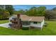 House exterior showcasing a back deck, large windows, and brick accents at 225 Cantering Hills Ln, Summerville, SC 29483