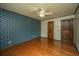 Hardwood floor bedroom with double doors and floral wallpaper at 225 Cantering Hills Ln, Summerville, SC 29483
