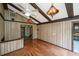 Bonus room with hardwood floors, wood-paneled walls, and ceiling beams at 225 Cantering Hills Ln, Summerville, SC 29483