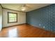 Bedroom with hardwood floors, window, and floral wallpaper on one wall at 225 Cantering Hills Ln, Summerville, SC 29483