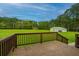 Large deck with brick flooring and stairs leading to a spacious yard with a detached garage at 225 Cantering Hills Ln, Summerville, SC 29483