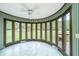 Sunroom with expansive windows offering a tranquil backyard view at 225 Cantering Hills Ln, Summerville, SC 29483