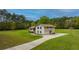 Two-story house with light beige siding, large windows, and a spacious yard at 225 Cantering Hills Ln, Summerville, SC 29483