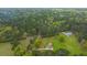 Aerial view of house on large lot with detached garage, showcasing expansive green space and surrounding trees at 225 Cantering Hills Ln, Summerville, SC 29483