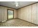 Bright bedroom featuring wood paneled walls and floral carpet at 225 Cantering Hills Ln, Summerville, SC 29483