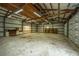 Spacious workshop, double garage doors, wooden beams, and shelving at 225 Cantering Hills Ln, Summerville, SC 29483