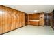 Clean basement with wood paneled walls and cabinets at 225 Cantering Hills Ln, Summerville, SC 29483
