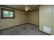 Simple bedroom with wood paneling, window, and carpet at 225 Cantering Hills Ln, Summerville, SC 29483