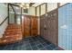 Inviting entryway with tiled floor, staircase, and double doors at 225 Cantering Hills Ln, Summerville, SC 29483