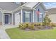 Charming house with landscaped front yard, American flag, and walkway at 381 Tupelo Lake Dr, Summerville, SC 29486