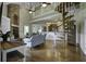 Open great room boasts a stone fireplace, spiral staircase, and hardwood floors at 120 Old Peafield Rd, Saint George, SC 29477
