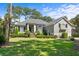 Two-story home with gray siding, black shutters, and lush landscaping at 2340 Marsh Hen Dr, Seabrook Island, SC 29455