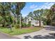 Gray sided home with black shutters and a large driveway at 2340 Marsh Hen Dr, Seabrook Island, SC 29455