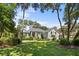 Beautiful two-story home with gray siding, black shutters and spacious lawn at 2340 Marsh Hen Dr, Seabrook Island, SC 29455