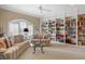 Spacious library with built-in bookshelves, comfortable seating, and large windows at 2340 Marsh Hen Dr, Seabrook Island, SC 29455