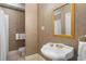 Bathroom with pedestal sink, shower, and patterned wallpaper at 2340 Marsh Hen Dr, Seabrook Island, SC 29455
