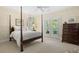 Bedroom with a four-poster bed, carpet, and access to patio at 2340 Marsh Hen Dr, Seabrook Island, SC 29455