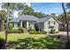 Single story home with gray siding, black shutters, and a manicured lawn at 2340 Marsh Hen Dr, Seabrook Island, SC 29455