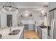 Modern kitchen with gray cabinets, white quartz countertops, and stainless steel appliances at 404 Sumter St, Charleston, SC 29403