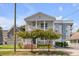 Two-story white house with a front porch and landscaping at 404 Sumter St, Charleston, SC 29403