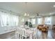 Open dining room and kitchen with white table and chairs at 210 Winding River Dr, Johns Island, SC 29455