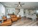 Open living room and dining area with hardwood floors and leather sectional at 210 Winding River Dr, Johns Island, SC 29455
