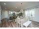 Dining area with white table and chairs adjacent to the kitchen at 210 Winding River Dr, Johns Island, SC 29455