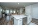 Open kitchen with white cabinets, stainless steel appliances, and island seating at 210 Winding River Dr, Johns Island, SC 29455