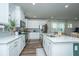 Bright kitchen features white cabinets, stainless steel appliances, and a large island at 210 Winding River Dr, Johns Island, SC 29455