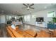 Open living room with brown leather sectional sofa, hardwood floors, and large TV at 210 Winding River Dr, Johns Island, SC 29455