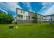 Rear view of townhomes with grassy area, raised foundation, and private decks at 210 Winding River Dr, Johns Island, SC 29455