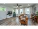 Living room with brown leather sectional, hardwood floors, and piano at 210 Winding River Dr, Johns Island, SC 29455
