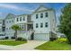 Two-story townhome with attached garage and American flag at 210 Winding River Dr, Johns Island, SC 29455