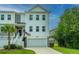 Two-story townhome with attached garage and American flag at 210 Winding River Dr, Johns Island, SC 29455
