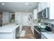 Open concept kitchen with white cabinets and stainless steel appliances at 210 Winding River Dr, Johns Island, SC 29455