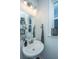 Stylish powder room with a pedestal sink, mirror, and decorative accents at 210 Winding River Dr, Johns Island, SC 29455