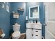 Stylish powder room with blue walls and white vanity at 320 Blue Shadows Ct, Summerville, SC 29486