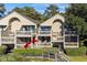Tan two-story home with large balconies, private entrance, and lush landscaping at 1351 Pelican Watch Villas, Seabrook Island, SC 29455