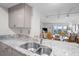 Kitchen with granite counters, double sink, and view into living area at 1351 Pelican Watch Villas, Seabrook Island, SC 29455