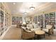 Relaxing library with comfortable seating and extensive bookshelves at 1351 Pelican Watch Villas, Seabrook Island, SC 29455