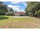House exterior featuring a two-car garage and spacious lawn at 6036 Postell Dr, Ravenel, SC 29470