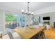 Dining room with sliding doors to deck, farmhouse table, and wood floors at 1010 E Erie Ave, Folly Beach, SC 29439