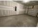 Unfinished garage with concrete floor and overhead door at 840 Descartes St, Summerville, SC 29486