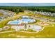 Aerial view of community pool and playground with surrounding houses at 628 Sweet Ramble Way, Summerville, SC 29486