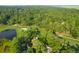 Aerial view of golf course, pond, and houses near marsh at 2523 Haulover Pointe Cir, Seabrook Island, SC 29455