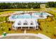 Community pool and clubhouse with a large lawn area at 630 Sweet Ramble Way, Summerville, SC 29486
