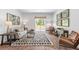 Living room with beige sofa and patterned rug at 630 Sweet Ramble Way, Summerville, SC 29486