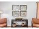 Console table with framed maps and wicker baskets at 630 Sweet Ramble Way, Summerville, SC 29486
