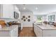 Modern kitchen with white cabinets, granite countertops, and stainless steel appliances at 630 Sweet Ramble Way, Summerville, SC 29486